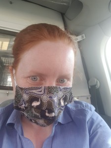 T L Whalan wearing a face mask